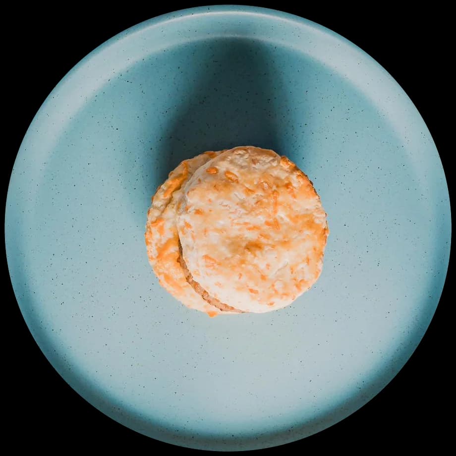 A Savannah Scone Company Scuffin, served on a blue plate and viewed from above